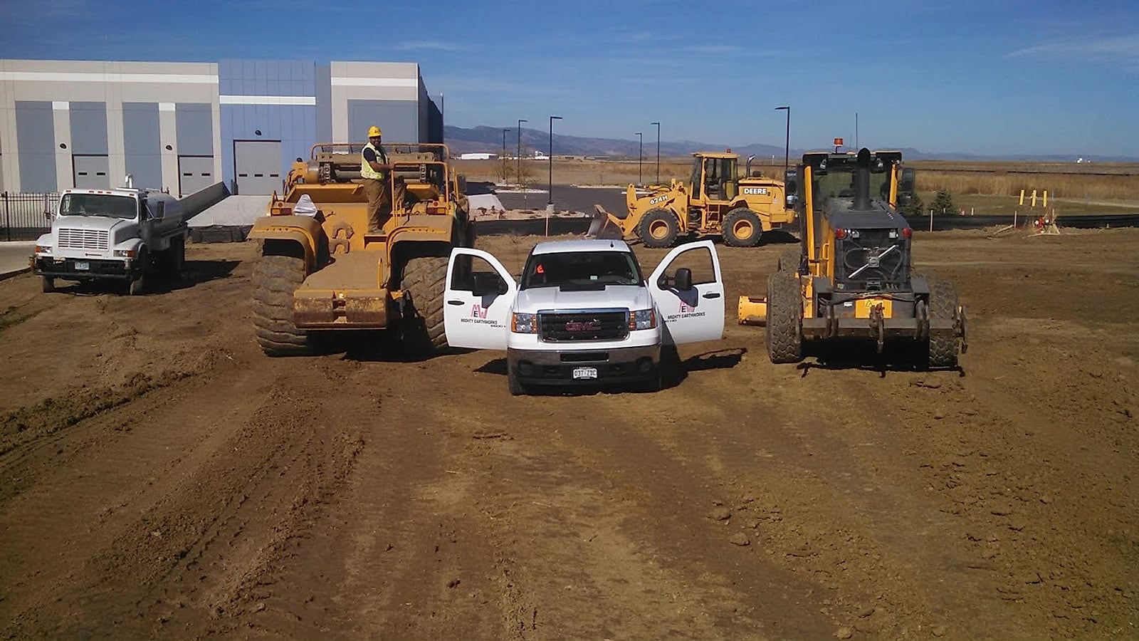 Motor grader performing precision grading on a large Arizona commercial site