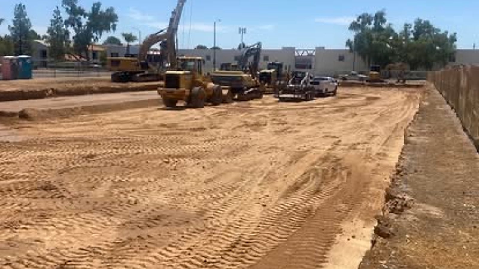 Mighty Earthworks equipment lined up on a finished Arizona building pad