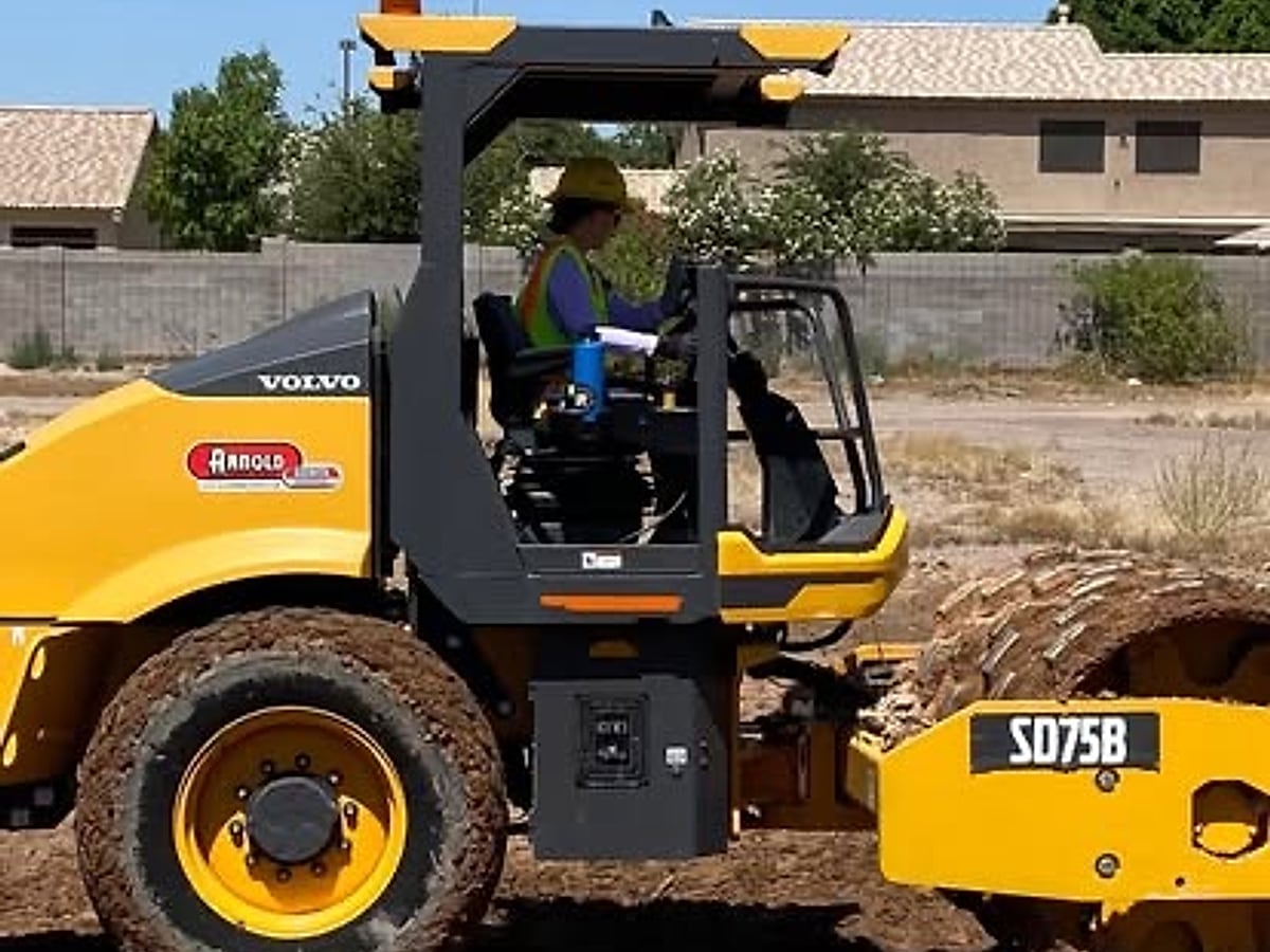Compaction roller working a prepared pad surface