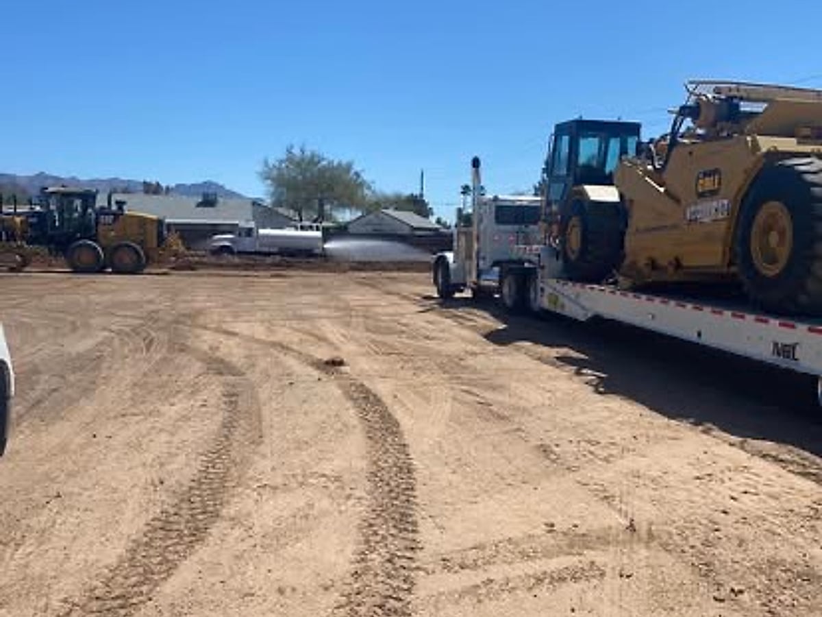 Heavy equipment delivered on a flatbed trailer